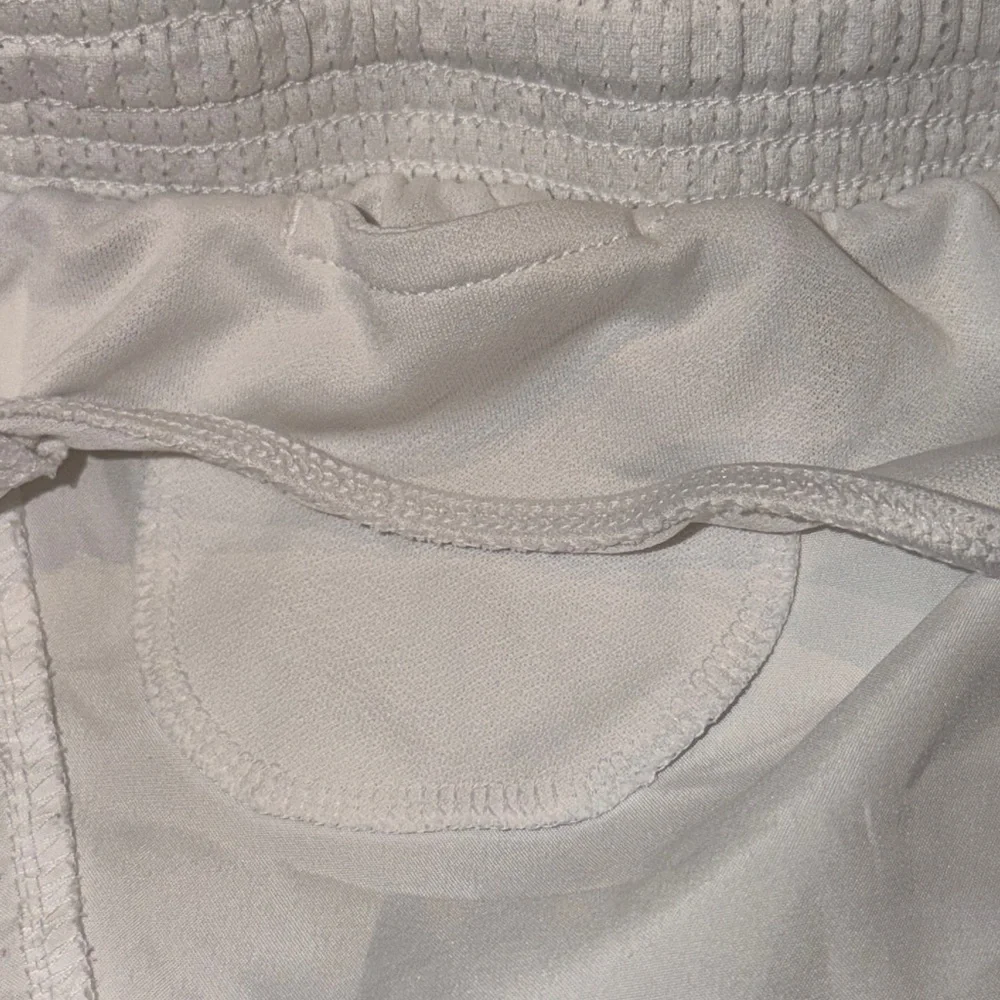 Nike Running Tempo Dri-FIT mid rise 3 inch shorts in white